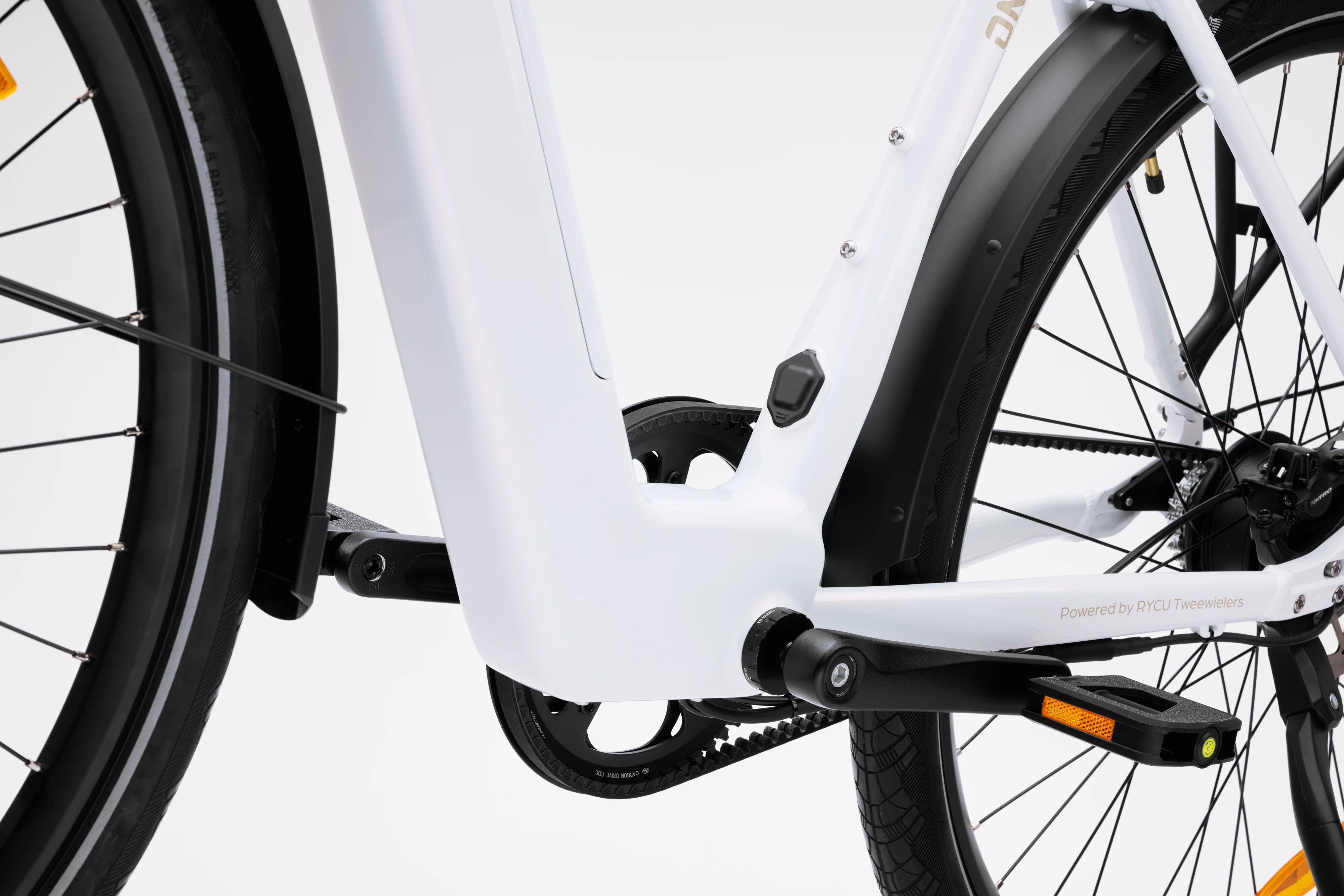 Studio low-angle detail shot of the bottom bracket, pedal crank arm, and lower step-through frame assembly of the pearlescent white Stry One electric bicycle.